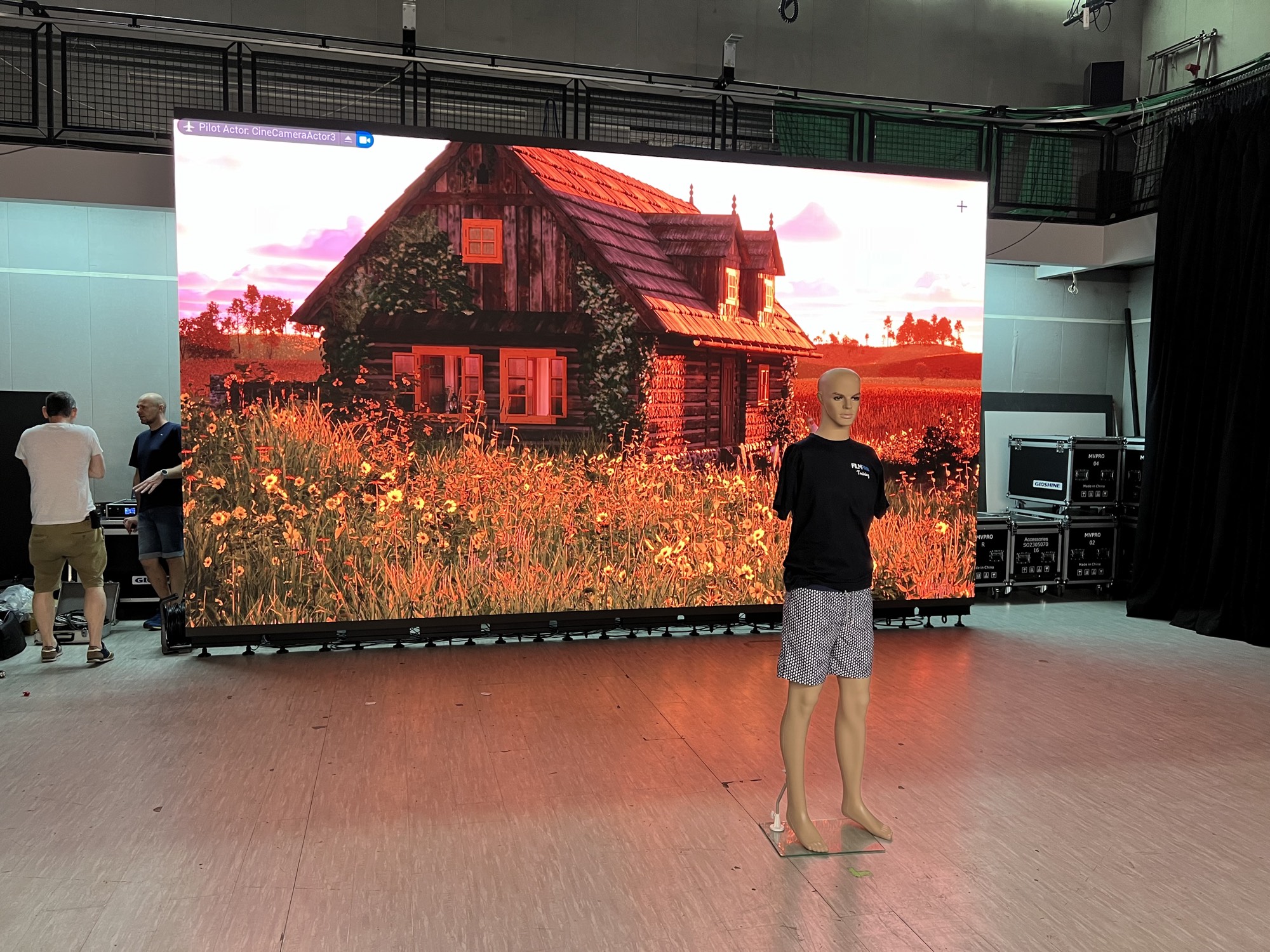 LED wall running the Unreal Engine scene with the editor's viewport overlay visible, a mannequin standing in as a lighting reference
