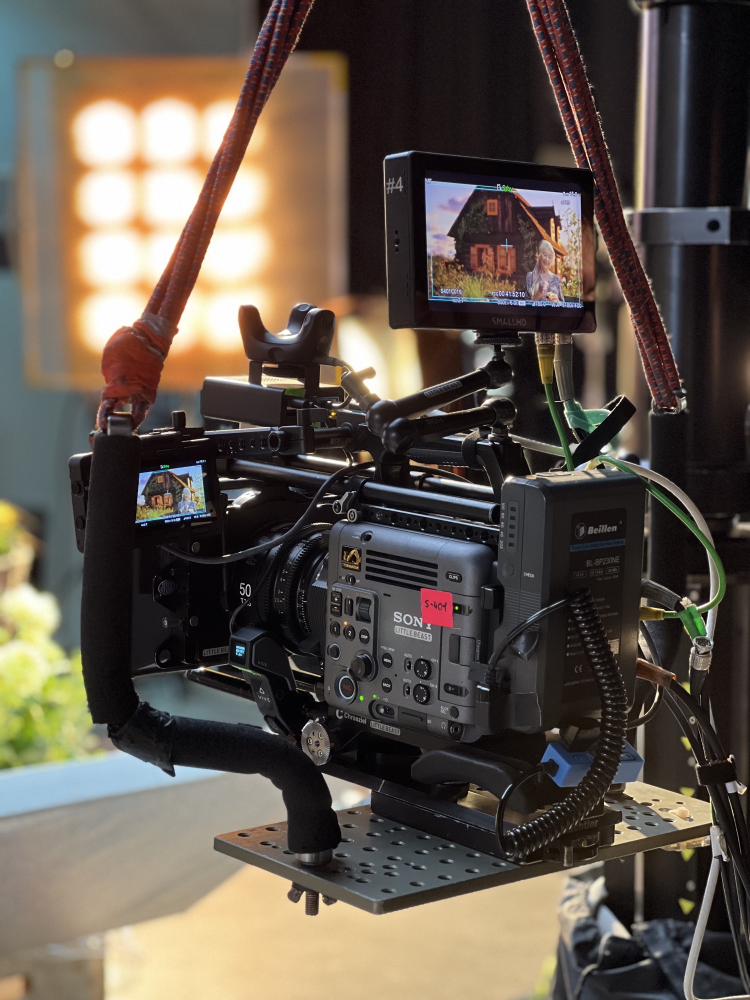 Camera rig with a tracker mounted to the body, on-board monitors showing the composited frame