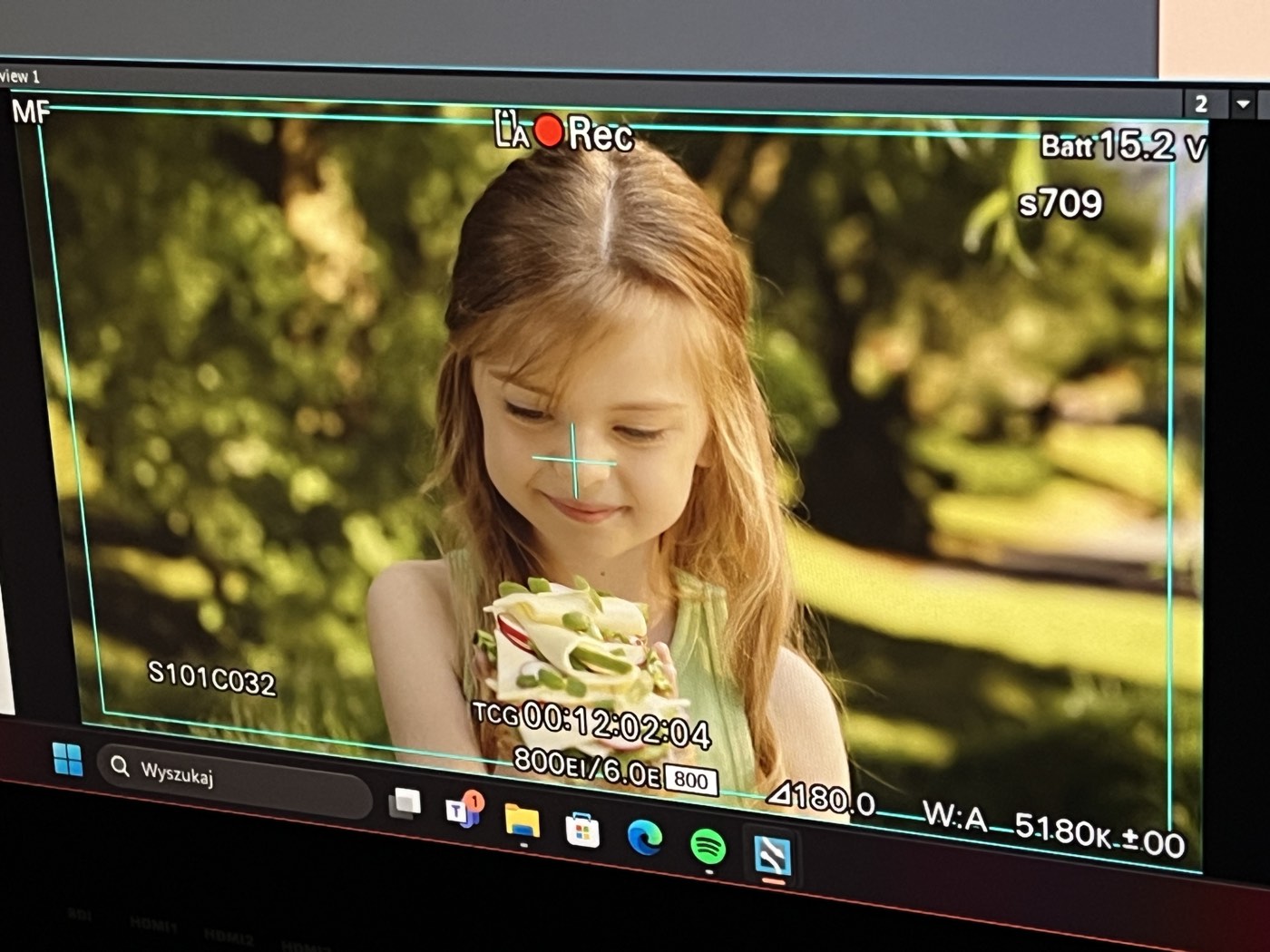 Camera monitor during a take, virtual orchard behind the subject