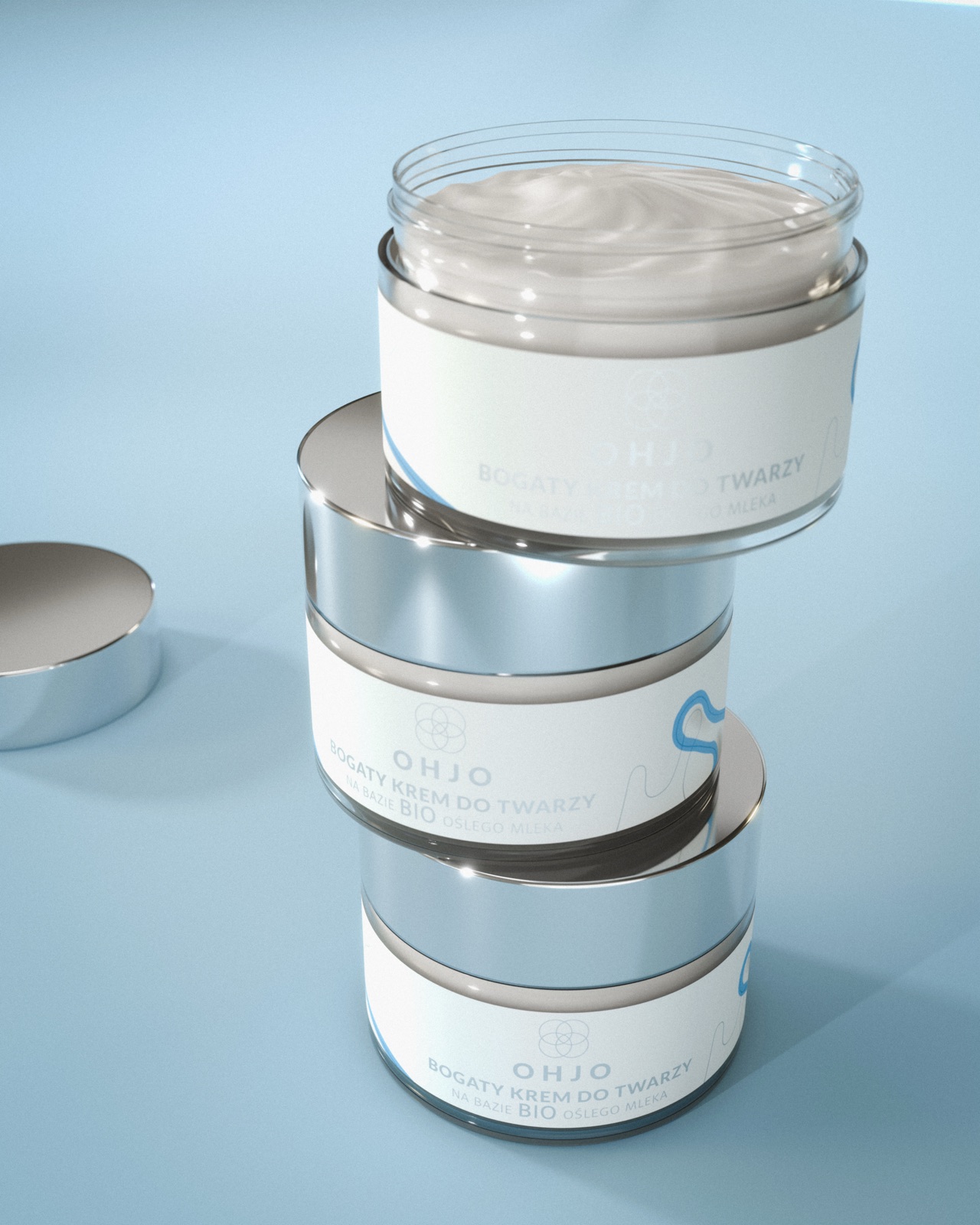 OHJO face cream jars stacked on a light blue studio background